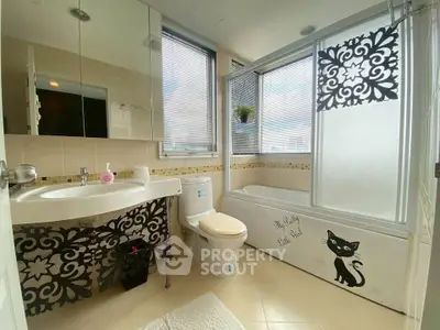 Charming bathroom with unique decor and modern fixtures, featuring a bathtub and stylish accents.