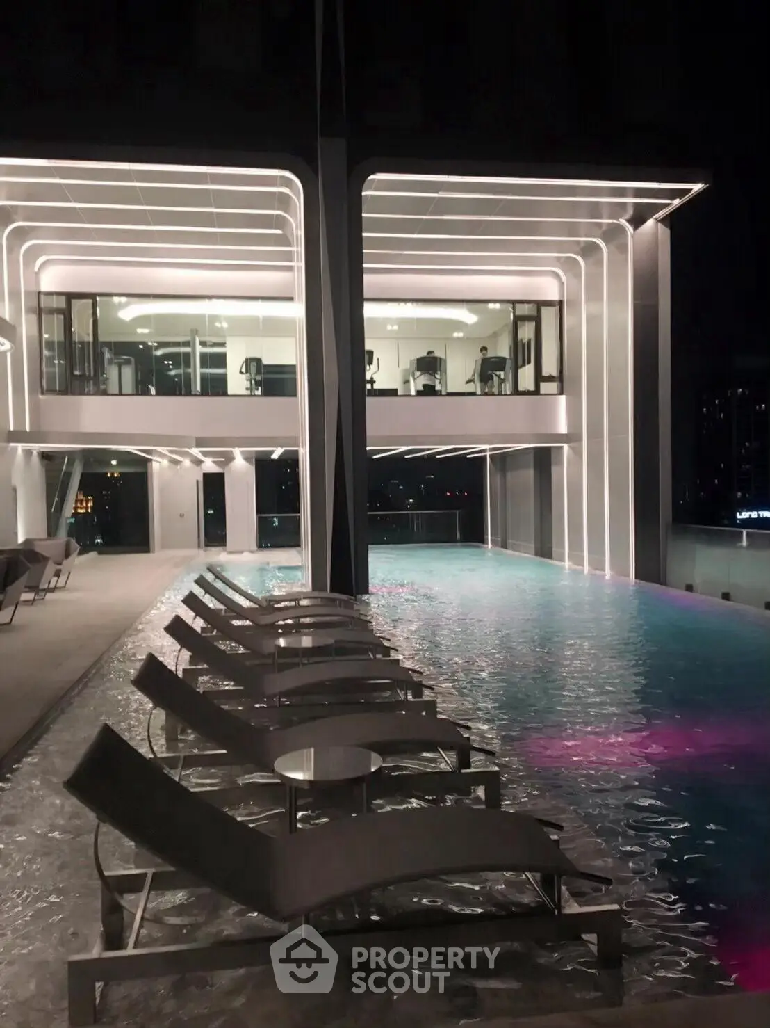 Luxurious rooftop pool with modern design and ambient lighting at night