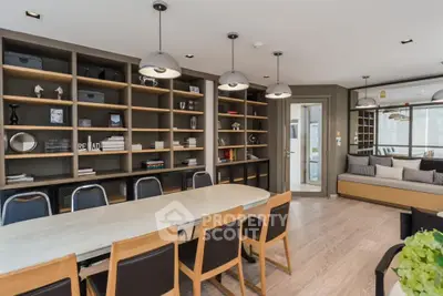 Modern study room with elegant shelving and spacious table in a stylish home.