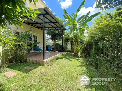 Charming garden view with covered patio in lush green backyard