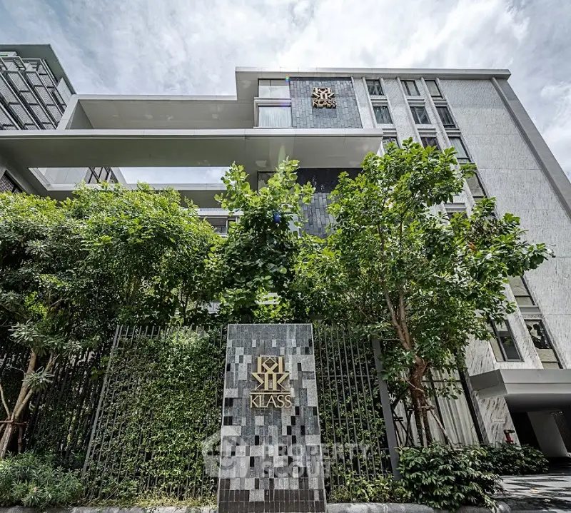 Modern architectural building with lush greenery and stylish facade