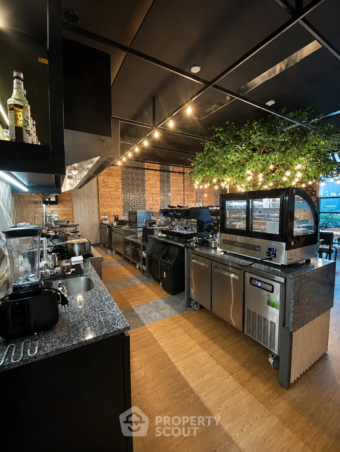 Modern commercial kitchen with stainless steel appliances and stylish lighting