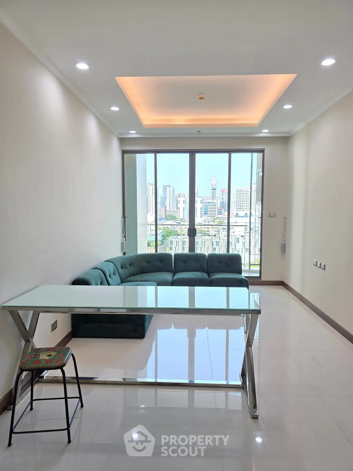 Modern living room with city view, featuring sleek furniture and large windows for natural light.