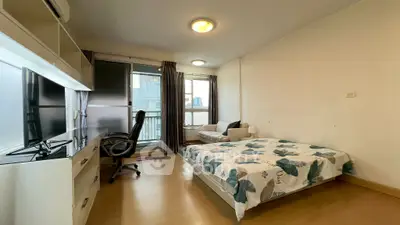 Spacious bedroom with modern decor and balcony access in urban apartment