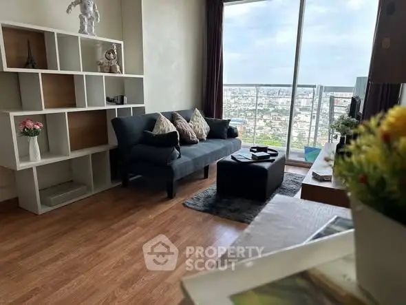 Stylish living room with modern decor and stunning city view from large window.