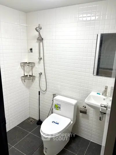 Modern bathroom with sleek fixtures and white tile walls