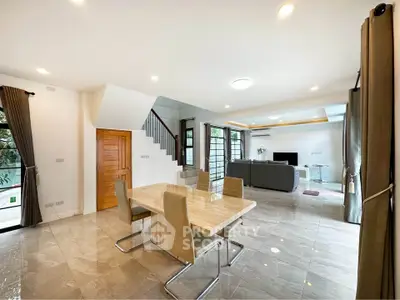 Spacious modern living room with elegant dining area and natural light