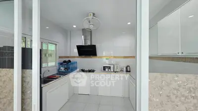 Modern kitchen with gas stove and sleek cabinetry in a bright, airy space.