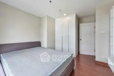 Spacious bedroom with modern design and ample natural light, featuring a large bed and built-in wardrobe.