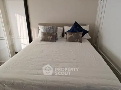 Cozy bedroom with stylish pillows and neutral decor