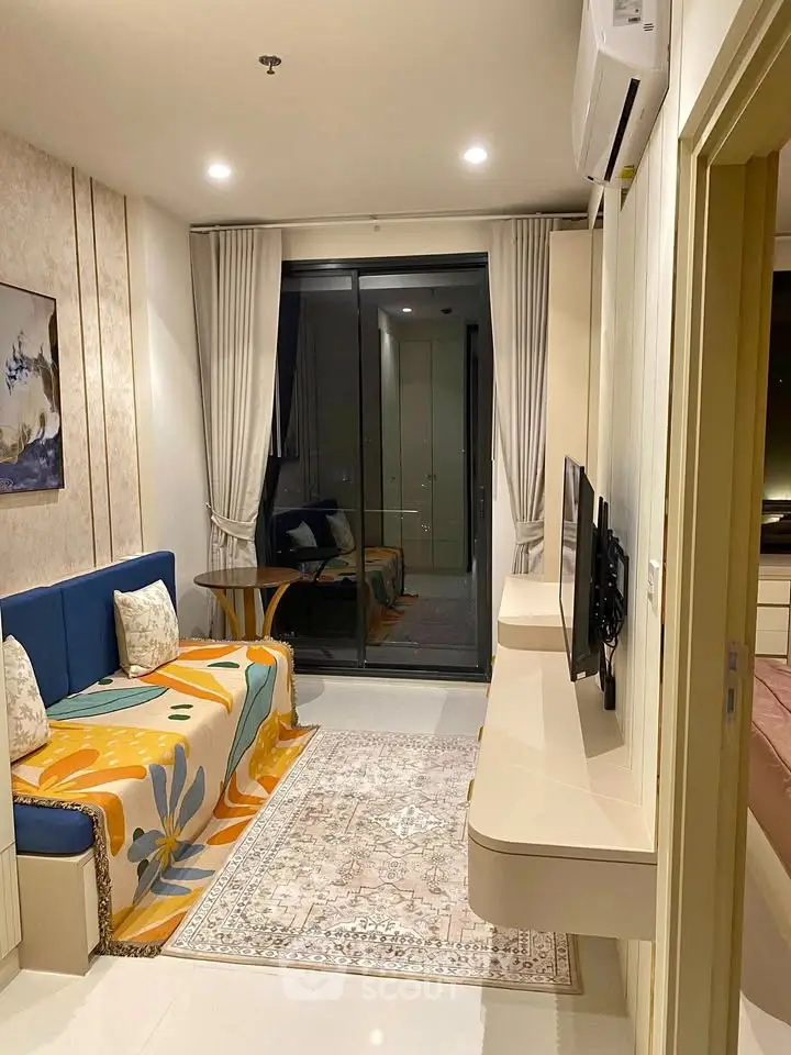 Modern living room with stylish decor and balcony access in a contemporary apartment.