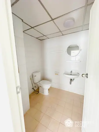 Spacious bathroom with modern fixtures and tiled flooring