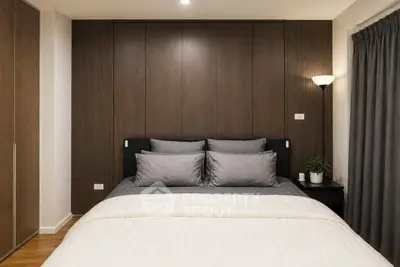 Modern bedroom with sleek design and cozy ambiance, featuring a stylish bed and elegant decor.