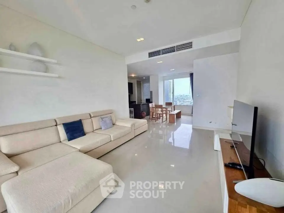 Spacious modern living room with sleek design and city view, perfect for urban living.