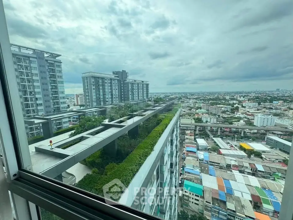 Stunning cityscape view from high-rise apartment window showcasing urban skyline and modern architecture.