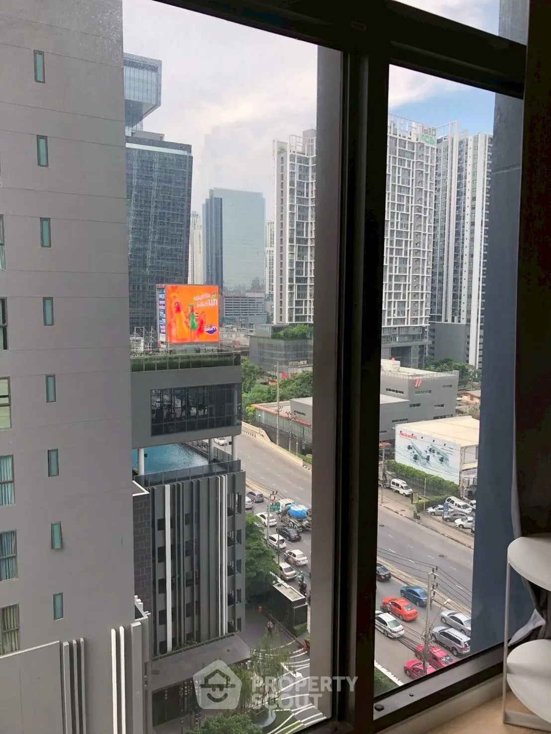 Stunning urban view from high-rise apartment window showcasing modern cityscape and skyline.