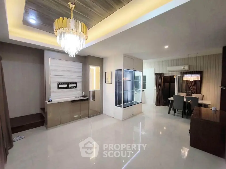 Spacious modern living room with elegant chandelier and open layout design