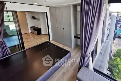 Modern bedroom with large windows and sleek design in urban apartment