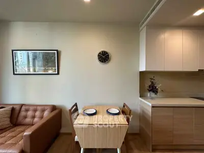 Modern living room with cozy dining area and sleek kitchen design