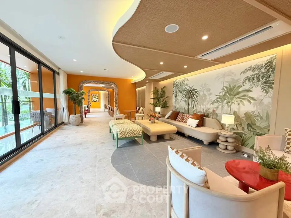 Luxurious open living room with tropical decor and poolside view