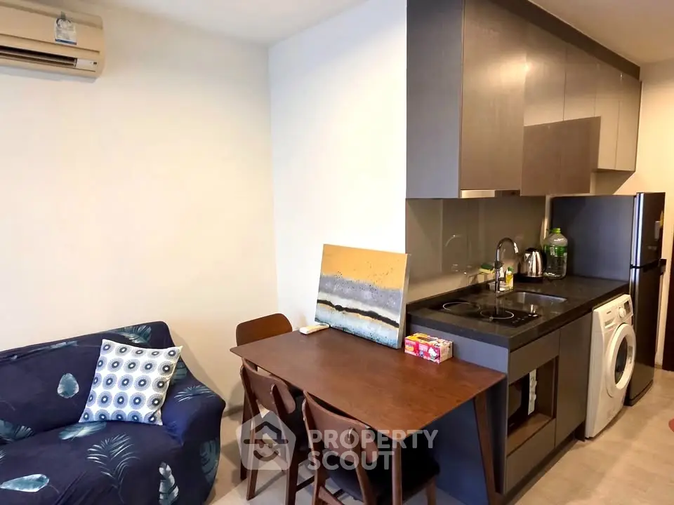 Cozy modern kitchen with dining area and washing machine in compact apartment