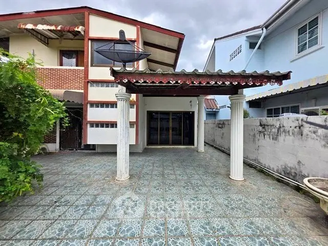 Charming residential property with spacious tiled driveway and classic architectural details.