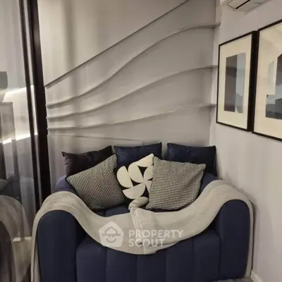 Stylish modern living room with cozy blue sofa and decorative wall art