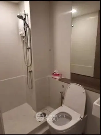 Modern bathroom with shower and toilet in compact space