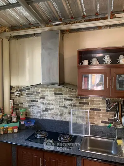 Charming kitchen with gas stove and modern cabinetry, ideal for culinary enthusiasts.