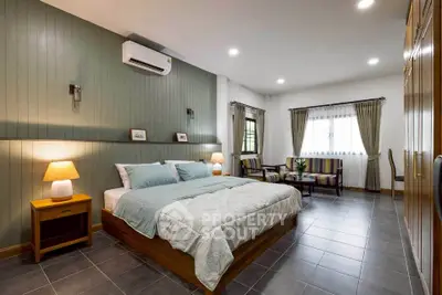 Spacious modern bedroom with elegant decor and ample natural light