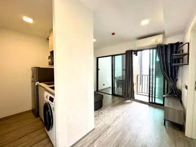 Modern apartment with open layout, featuring a washing machine and balcony access.