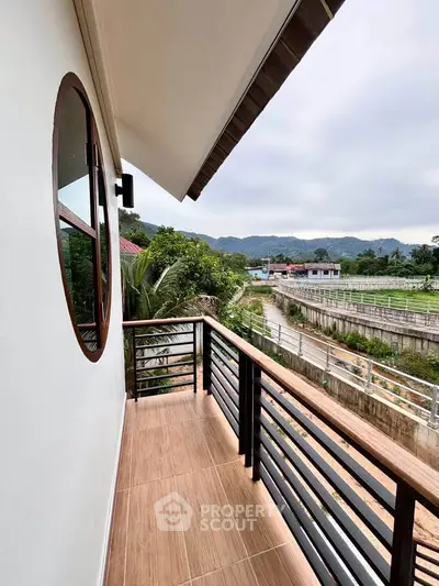Charming balcony with scenic mountain views and modern railing design.
