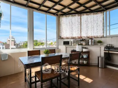 Spacious kitchen with large windows and modern appliances, offering a bright and airy atmosphere.