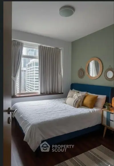 Cozy bedroom with city view, stylish decor, and natural light