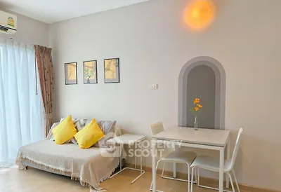 Charming living room with cozy sofa, dining table, and bright decor