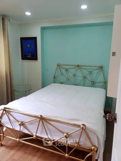 Charming bedroom with elegant metal bed frame and cozy decor