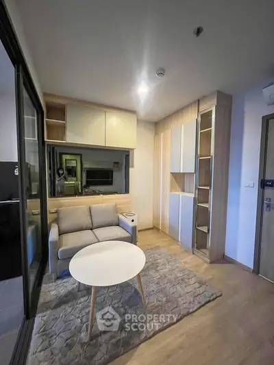 Modern living room with cozy sofa and stylish storage solutions in a contemporary apartment.