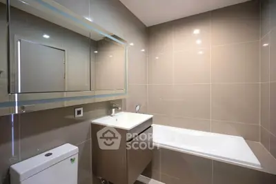 Modern bathroom with sleek design and bathtub in contemporary apartment.