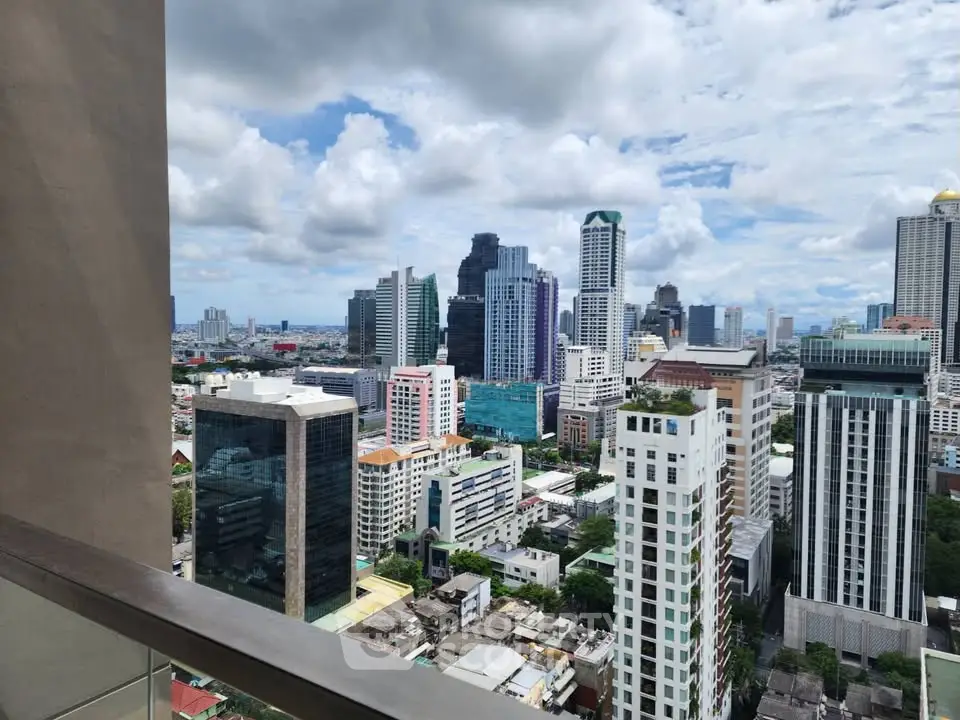 Stunning cityscape view from a high-rise balcony showcasing modern skyscrapers and vibrant urban life.