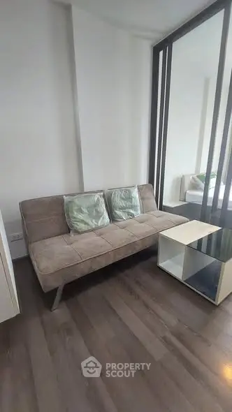 Modern living room with sleek sofa and stylish coffee table in a cozy apartment.