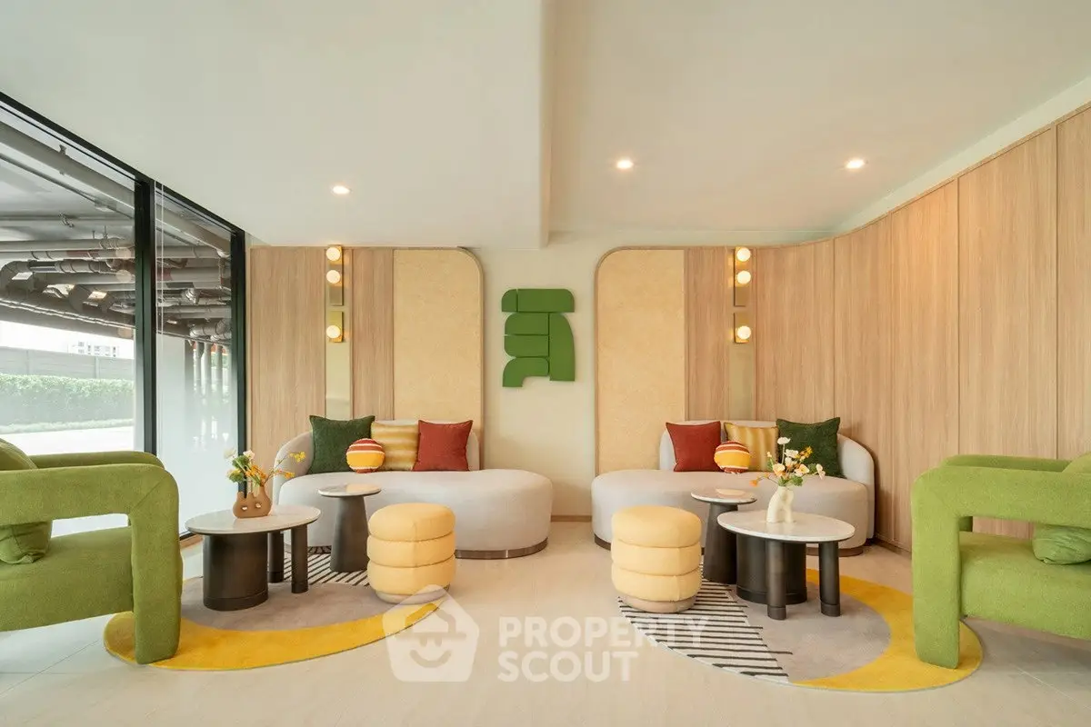 Stylish modern living room with vibrant furniture and large windows, perfect for relaxation and entertaining.