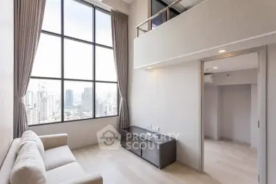 Spacious modern living room with large windows offering stunning city views in a high-rise apartment.