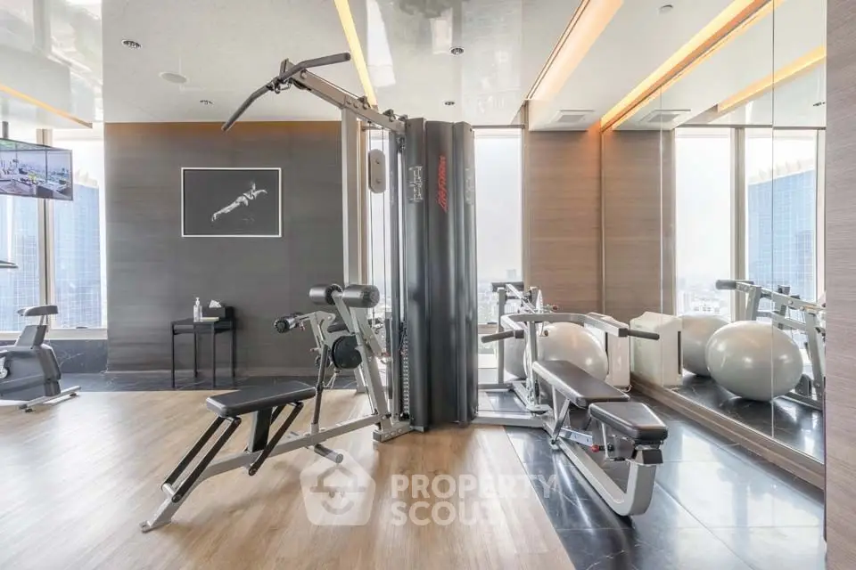 Luxurious gym with modern equipment and city view, perfect for fitness enthusiasts.