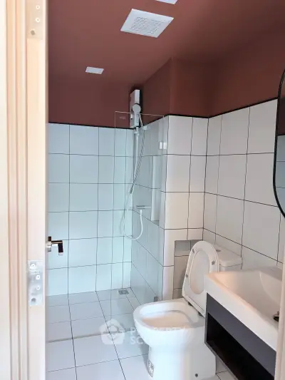 Modern bathroom with sleek white tiles and contemporary fixtures