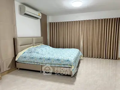 Spacious bedroom with modern decor and air conditioning