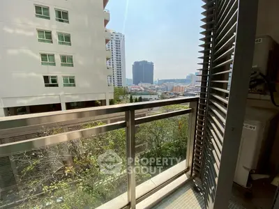 Stunning balcony view with cityscape and modern building architecture.