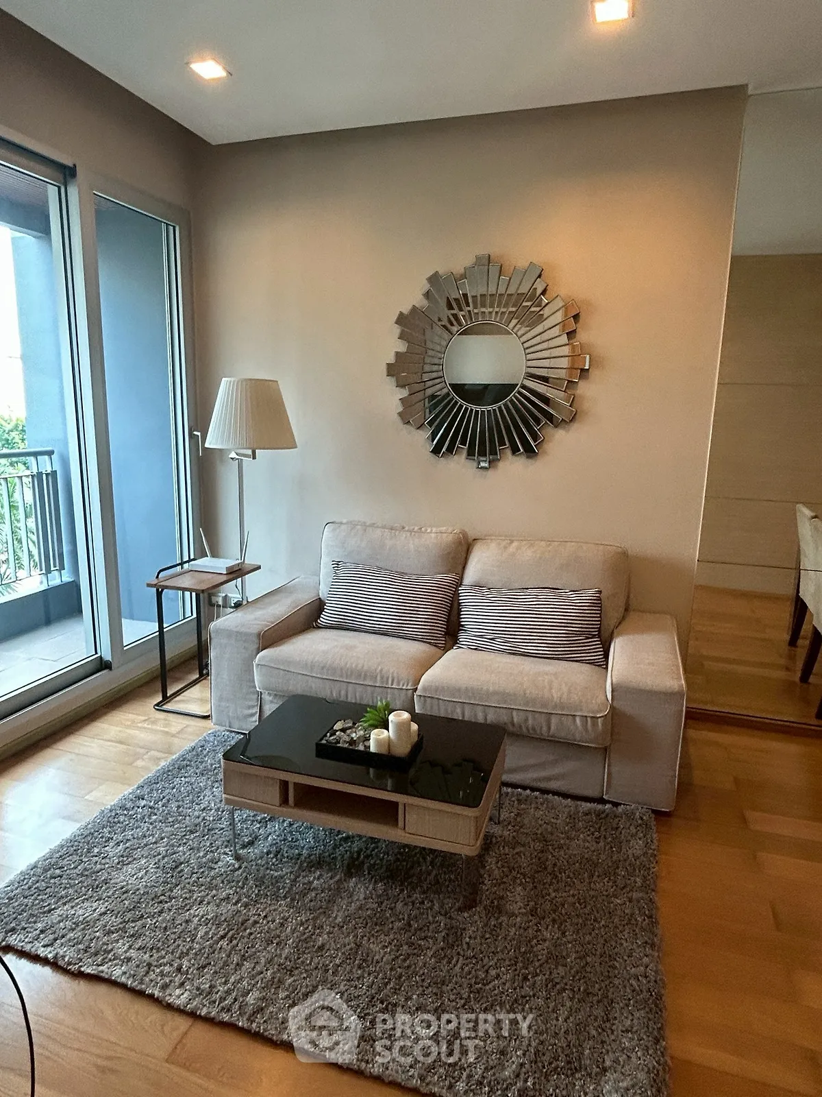 Chic living room with modern decor and balcony access in a stylish apartment.