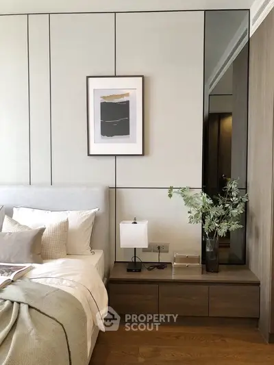Elegant bedroom with modern decor and cozy ambiance, featuring stylish artwork and sleek furniture.