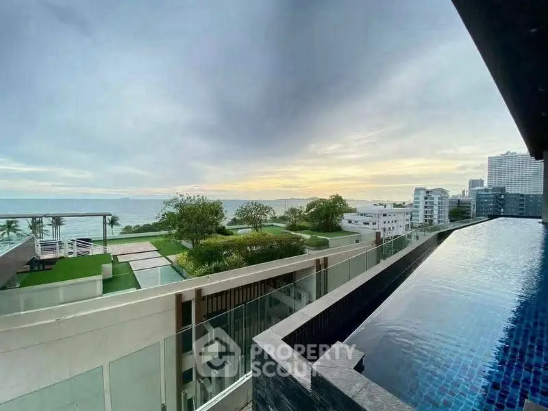 Stunning rooftop pool with panoramic ocean view in luxury condominium.