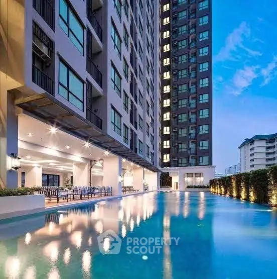 Luxurious high-rise building with stunning poolside view at sunset, perfect for modern urban living.